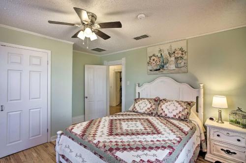 a bedroom with a bed and a ceiling fan at Decatur Farmhouse Getaway with Deck and Backyard in Decatur