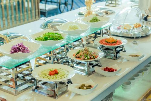 a buffet with plates of food on a table at THE SHINE HOTEL in Hai Phong