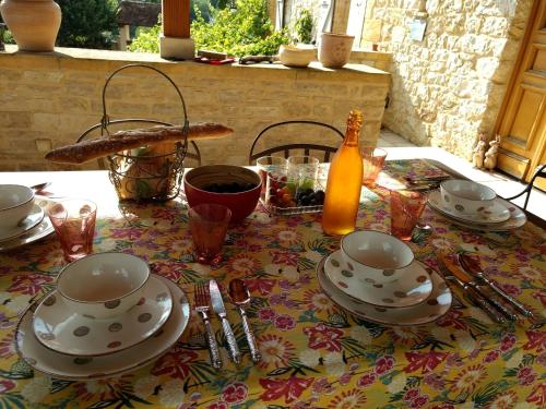 a table with plates and dishes on a table at La Lezardiere in Gourdon-en-quercy