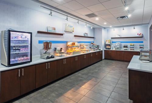 a large room with wooden cabinets in a store at Holiday Inn Express & Suites - Coffeyville by IHG in Coffeyville