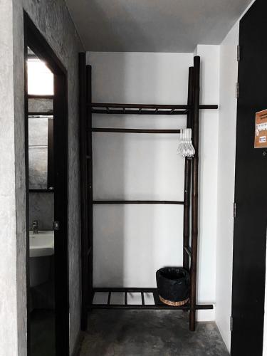 a bathroom with a sliding glass door with a bath tub at Lamphu House Chiang Mai in Chiang Mai