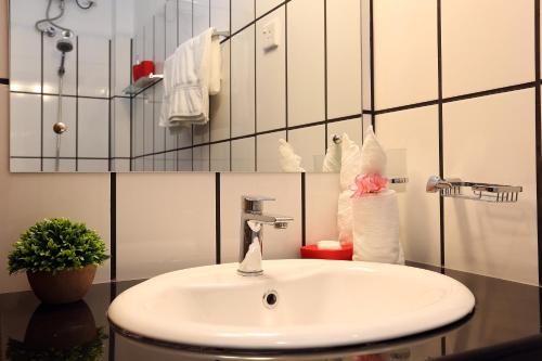 a bathroom with a sink with a towel at Iddamal Apartments in Mount Lavinia