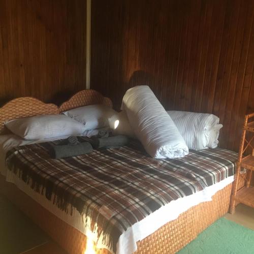 a bed with white pillows on it in a room at Sadyba Pidkova Чан сауна Приймаємо групи до 70людей in Pistyn