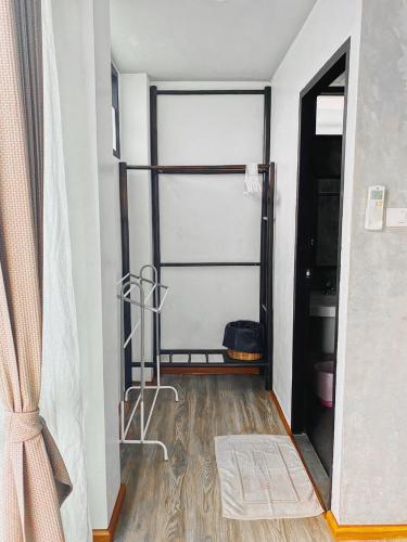 a room with a closet with a glass door at Lamphu House Chiang Mai in Chiang Mai