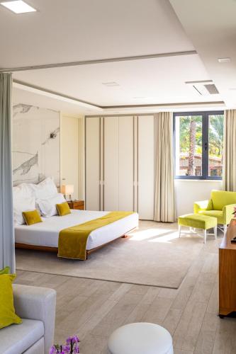 a bedroom with a king sized bed and a couch at Fazenda Viegas in Lagos