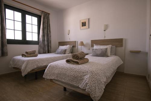 Ein Bett oder Betten in einem Zimmer der Unterkunft Paradise Club