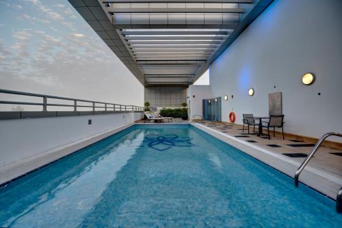 a swimming pool in a building with a ceiling at Royal Continental Suites Business Bay - Deluxe Apartments in Dubai