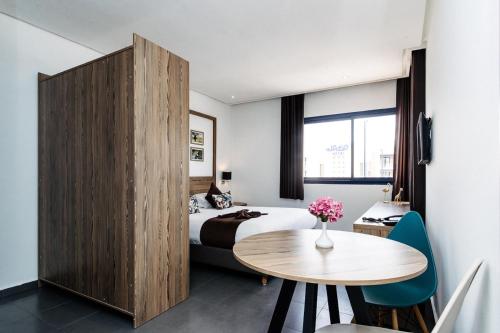 Voodi või voodid majutusasutuse Wazo Appart-Hôtel toas
