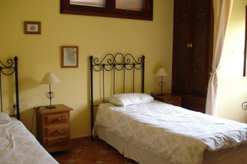 een slaapkamer met 2 bedden, 2 lampen en een raam bij Casa Karen in Vallehermoso