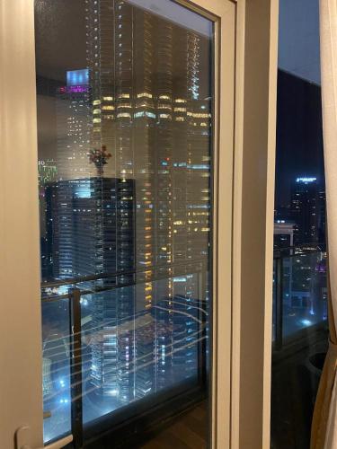 a window with a view of a city at night at Avenue K in Kuala Lumpur