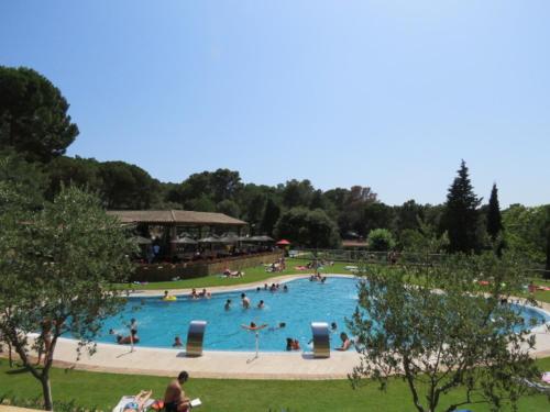 a large swimming pool with people in a park at Europe tents camping Begur in Begur
