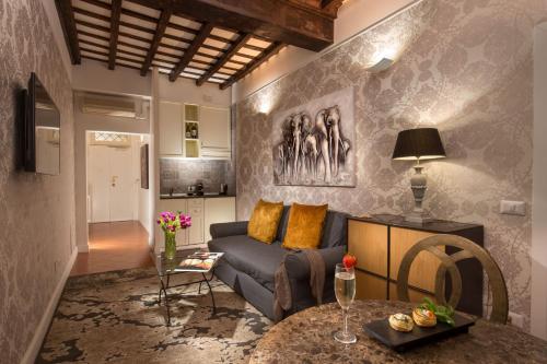 a living room with a couch and a table at The Inn Apartments Spagna by The Goodnight Company in Rome