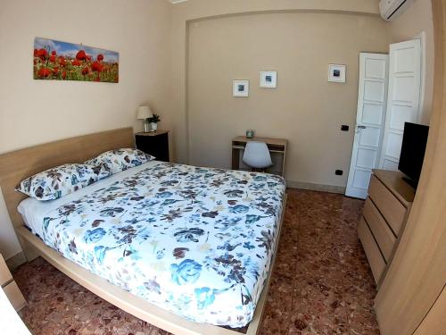 a bedroom with a bed and a television in it at La Casa di Aurora in Reggio Calabria