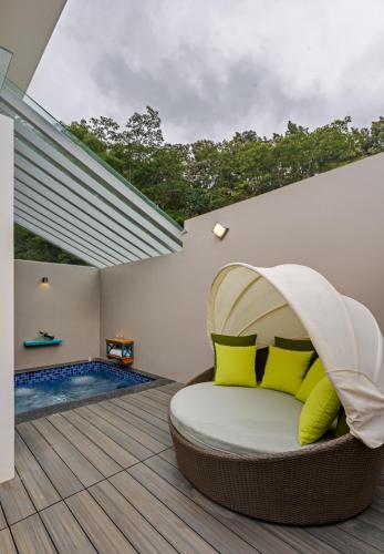 a room with a round bed with yellow pillows at Vismita County in Chikmagalūr