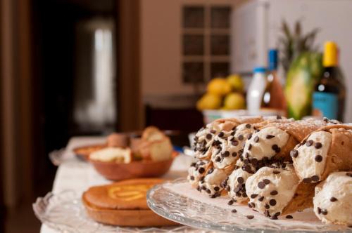a table with a plate of bread and pastries at B&B Ruggero I di Sicilia in Piazza Armerina