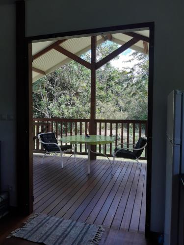 a patio with a table and chairs on a deck at Kaz'a fred in Guenouillet