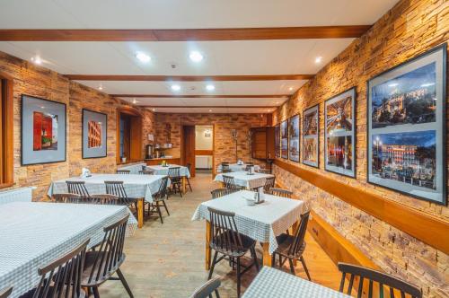 a restaurant with tables and chairs and pictures on the walls at U Musa in Karpacz