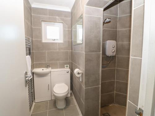 a small bathroom with a toilet and a sink at Bankwell Cottage in Newcastle upon Tyne