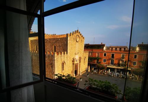 a window view of a building with a clock tower at Casa Viola - Al Centro in Taormina