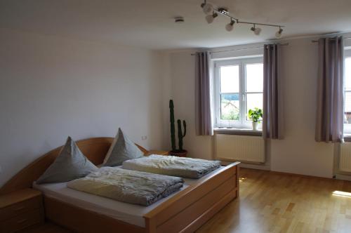 a bedroom with a bed with two pillows on it at Ferienwohnung St. Georg in Hemau