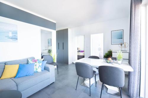 a living room with a couch and a table at Villa Sunset Sea in Krk