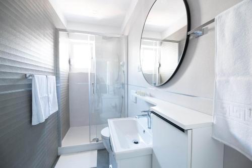 a white bathroom with a sink and a mirror at Villa Sunset Sea in Krk