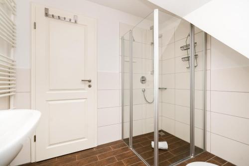 a bathroom with a shower with a glass door at Appartement Lille Kamp 2 in Westerland
