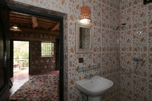 a bathroom with a sink and a mirror at Chez Hafid House in Imlil