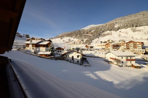 a village in the snow with a mountain at Chalet EDELWEISS in Ladis