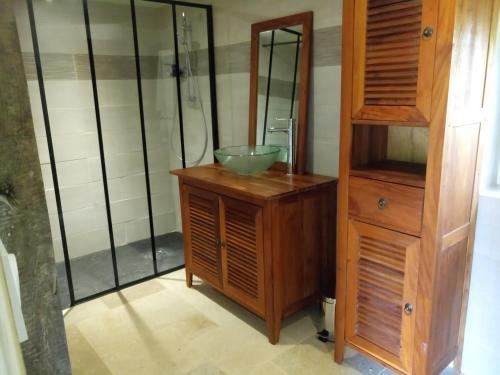 a bathroom with a bowl sink on a wooden cabinet at la providence in Boudeville