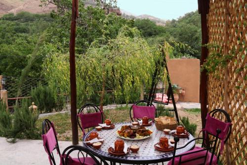 a table with a plate of food on it at Tonaroz House in Imlil