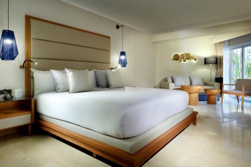 
a bedroom with a large bed and a large window at Grand Palladium Punta Cana Resort & Spa - All Inclusive in Punta Cana
