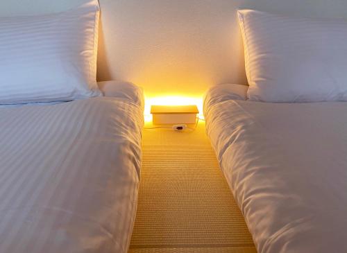 Postel nebo postele na pokoji v ubytování Hotel Hanafuji Inn