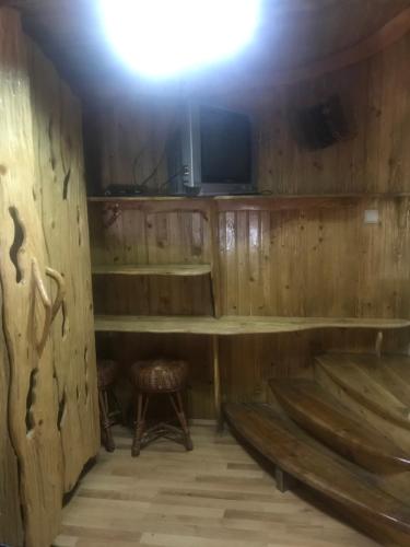 a room with a wooden cabin with a tv and a bench at Sadyba Pidkova Чан сауна Приймаємо групи до 70людей in Pistyn