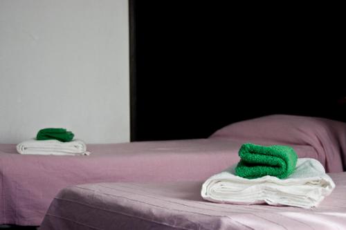two towels sitting on top of a bed at Villa Elisabetta in Venice-Lido