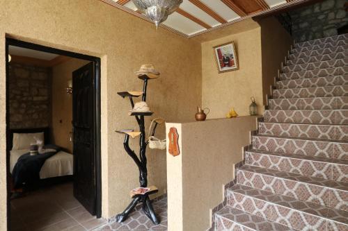 a room with stairs and a bedroom with a bed at Tonaroz House in Imlil