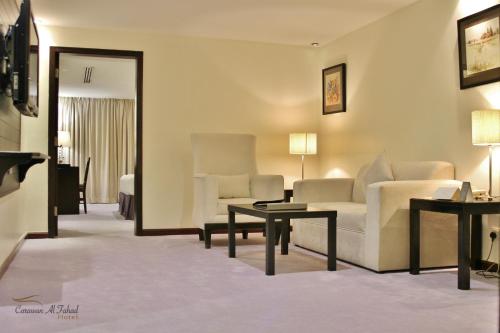 a living room with a couch and a table at Carawan Al Fahad Hotel in Riyadh