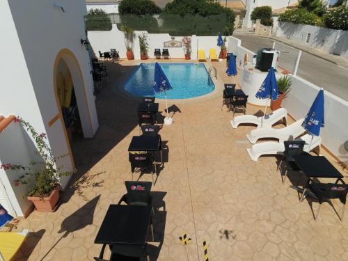 an overhead view of a swimming pool with chairs and umbrellas at Agua Marinha ROSA- Hotel in Albufeira