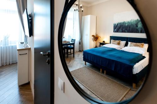 a bedroom with a bed and a mirror at BOHO HOUSE in Ustrzyki Dolne
