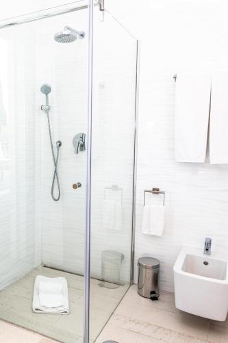 a bathroom with a shower and a sink at Fazenda Viegas in Lagos