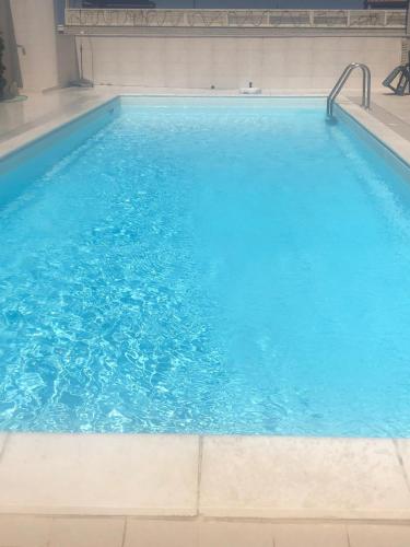 a large swimming pool with blue water at Palese Profumo di Mare in Santo Spirito