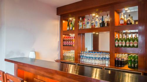 a bar with a lot of bottles of alcohol at Hotel Shangrila Regency in Darjeeling