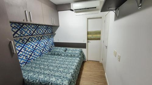 a small room with a bed and a hallway at Estudio Alto da Boa Vista in Sao Paulo