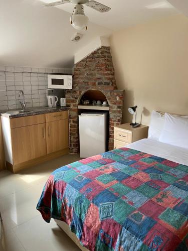a kitchen and a bedroom with a bed in a room at Seven Dials Studio in London