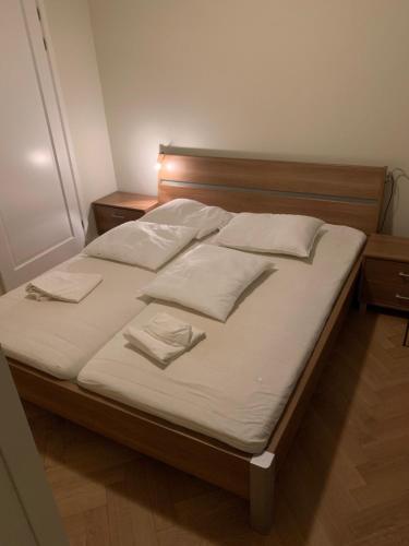 a bed with white sheets and pillows on it at Vakantiehuis Villa Zeewolde in Zeewolde