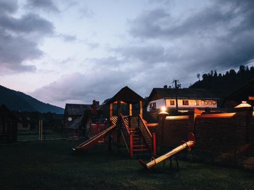 a park with a playground with a slide at Котедж "Romanna" in Slavske