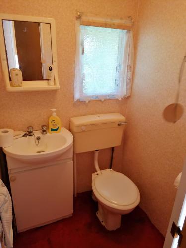 a small bathroom with a toilet and a sink at Medumi Lake in Medumi