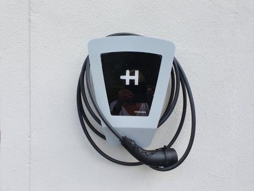 a person taking a picture of a cross on a wall at Moselfeeling co2frei in Cochem