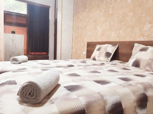 a bedroom with two beds and a window at Студио Теа 2 in Sliven