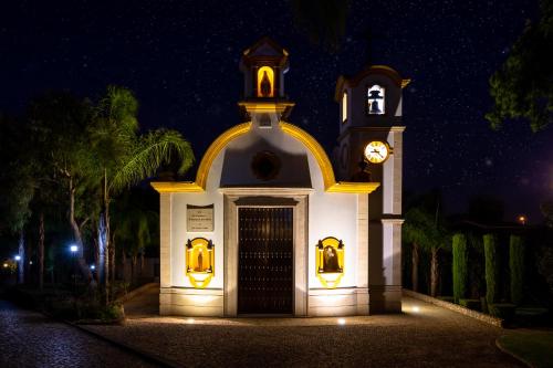 a church with a clock tower at night at Fazenda Viegas in Lagos